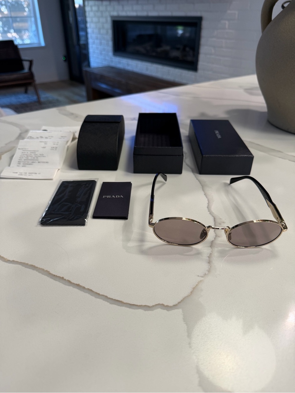 Prada Gold Frame Oval Sunglasses with Brown-Tinted Lenses